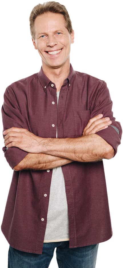 Smiling middle-aged man in casual clothing with arms crossed, standing against a white background; commonly featured in marketing for small business to convey approachability and confidence.